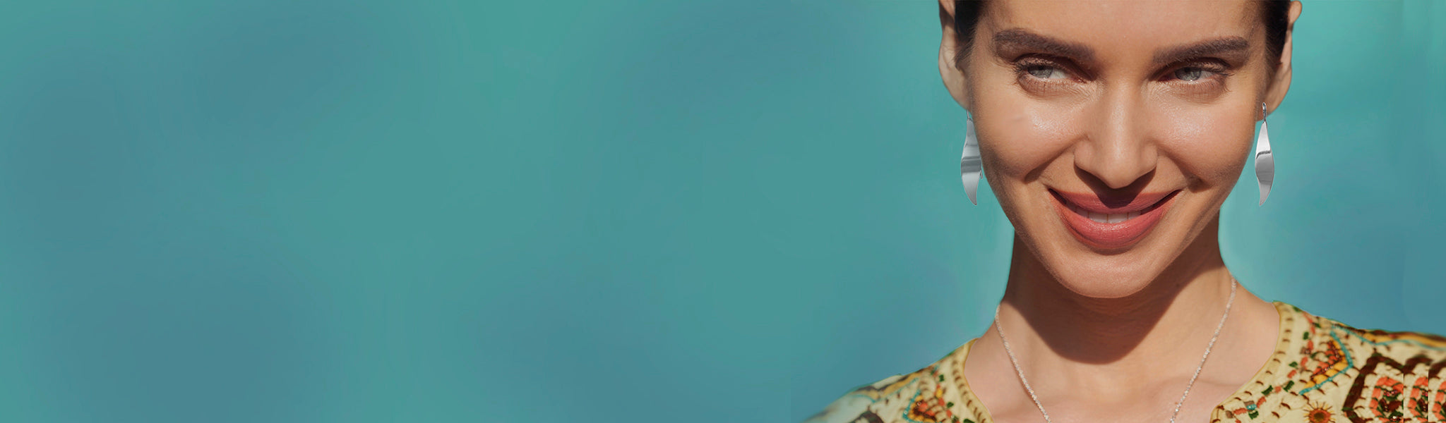 Smiley model wearing earrings from the Christmas jewellery gifts under £30 Selection