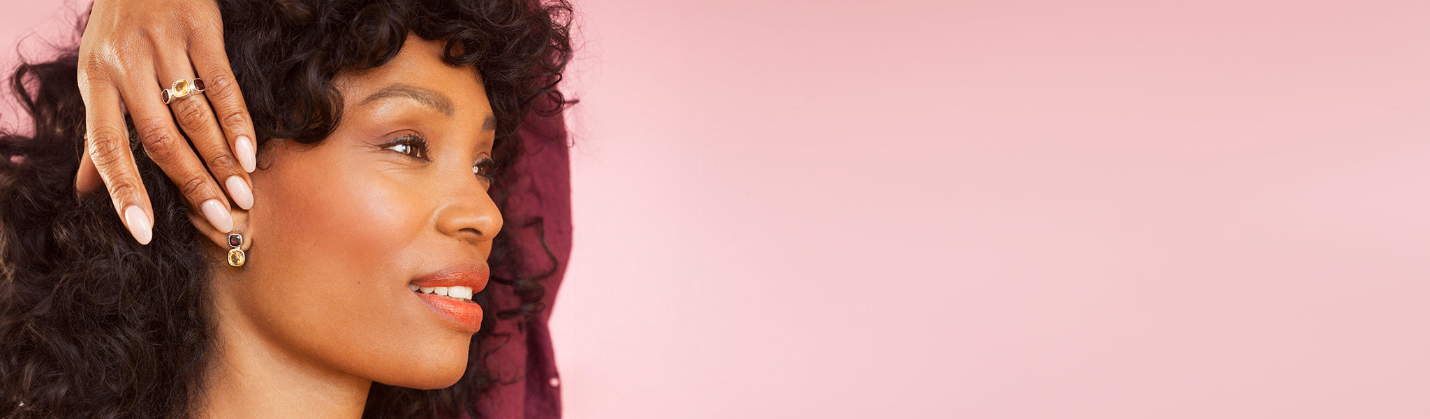 A model wearings some earrings and matching ring with November birthstones from the Birthday collection