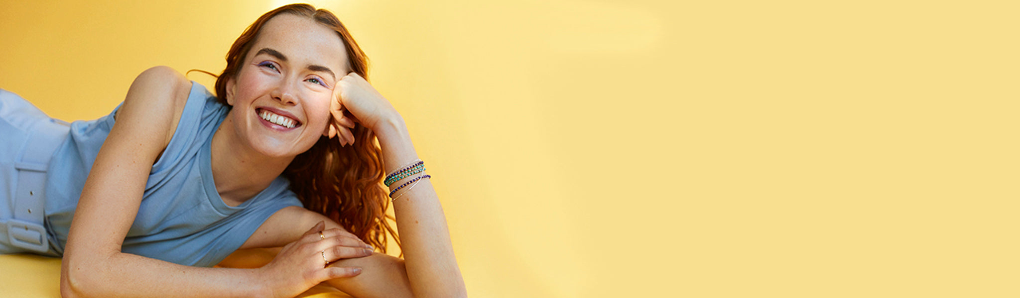 Cute model wearing silver and gemstone bracelets showcasing Christin Ranger's collection of womens bracelets in silver and gold