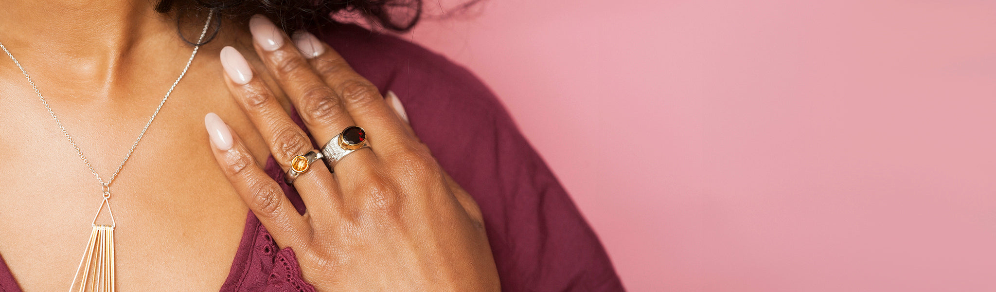 Model wearing elegant silver, gold, and gemstone statement rings showcasing bold, handcrafted designed statement rings in silver and gold