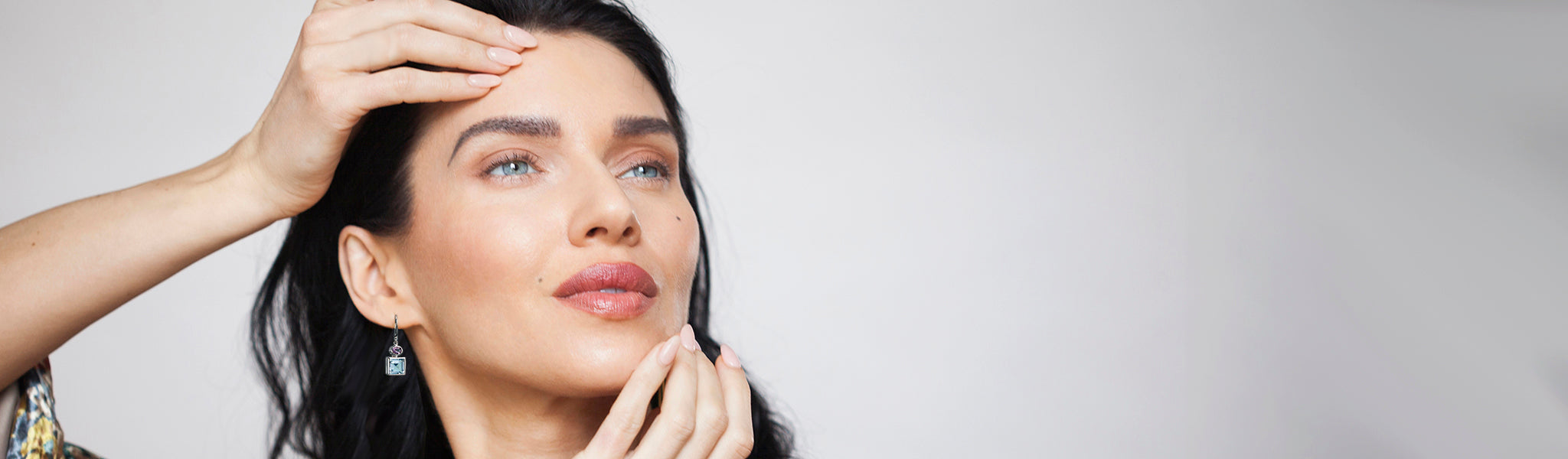 Our model wearing the best selling blue topaz and amethyst drop earring in silver from Christin Ranger Jewellery