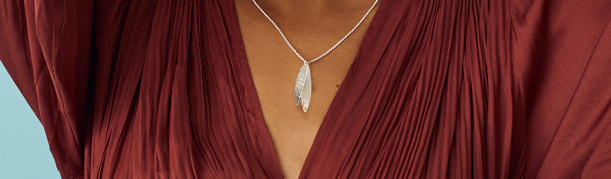 Close-up of model showcasing a silver necklace from Christin Ranger's modern and contemporary necklace collection in silver and gold.