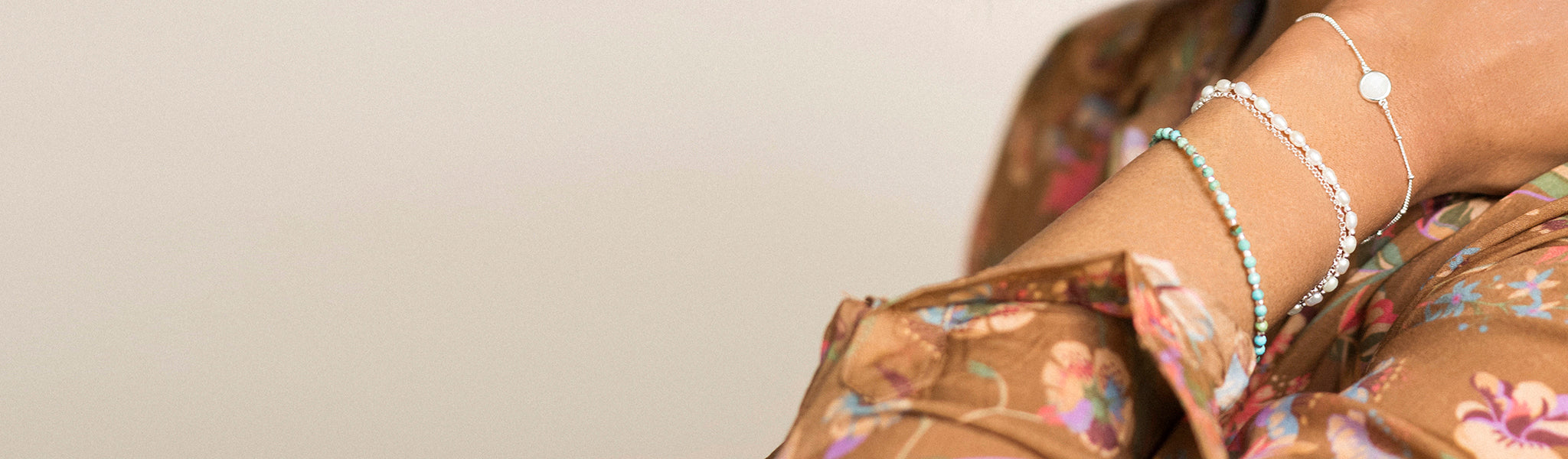 Close-up of model wearing three bracelets from Christin Ranger's  from her stunning, natural silver and gold vermeil gemstone and pearl bracelets collection