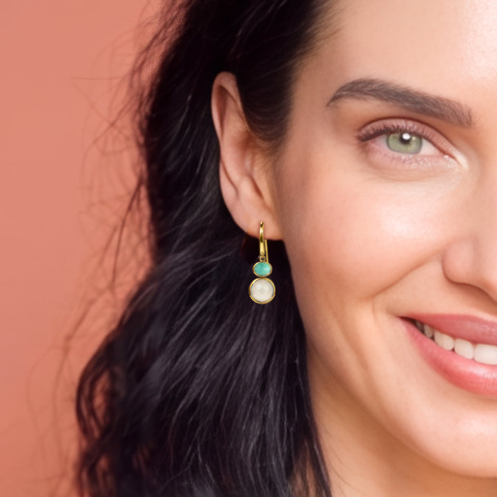 Close-up of woman wearing 18ct gold vermeil drop earrings with moonstone & amazonite