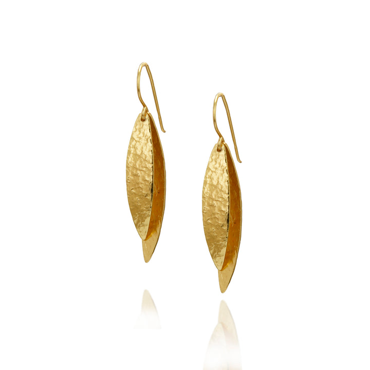 Pair of gold long drop earrings on a white background
