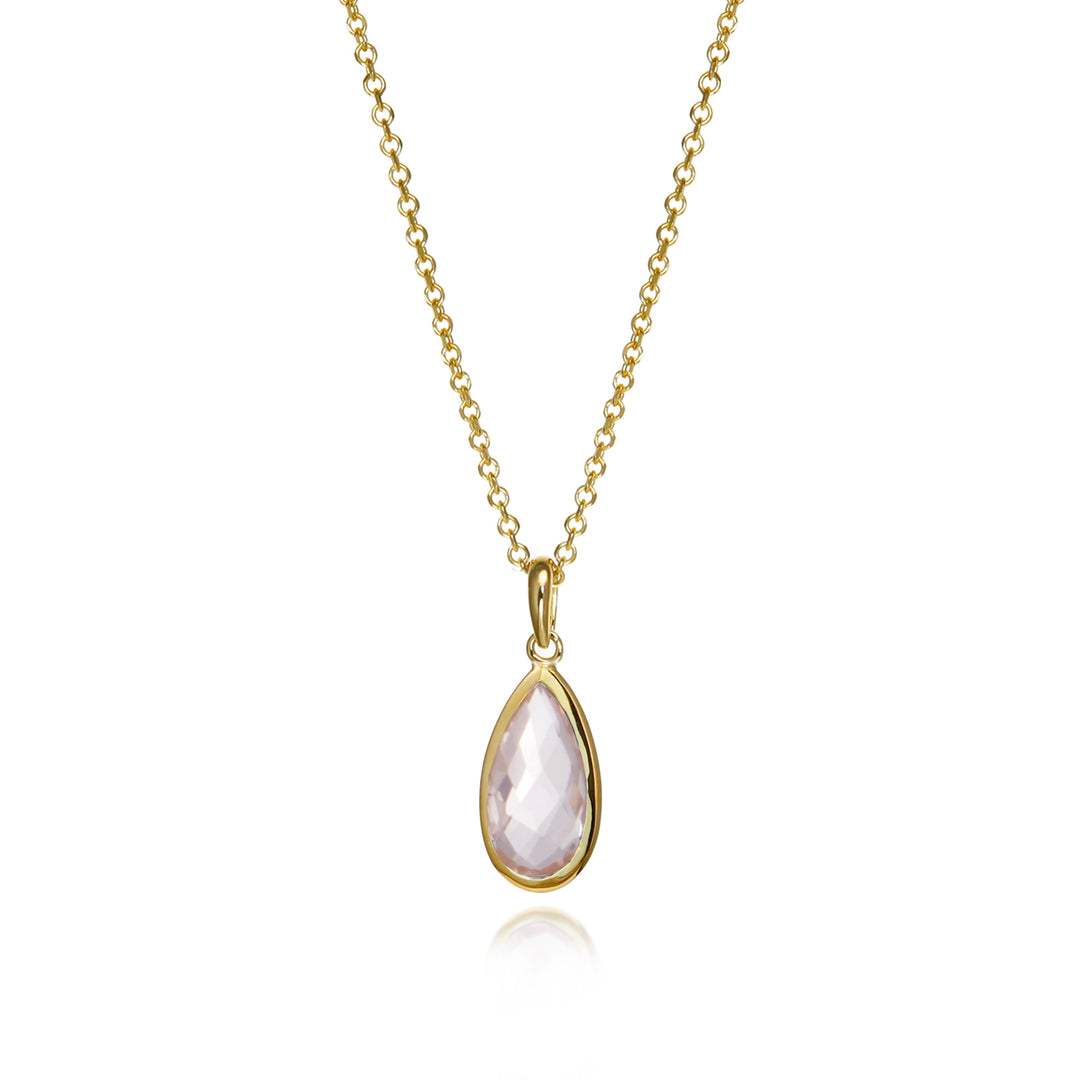 Gold necklace with a teardrop-shaped gemstone pendant on a white background