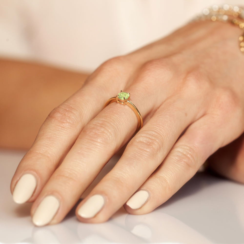 Close-up of woman wearing a peridot ring in 18ct gold vermeil