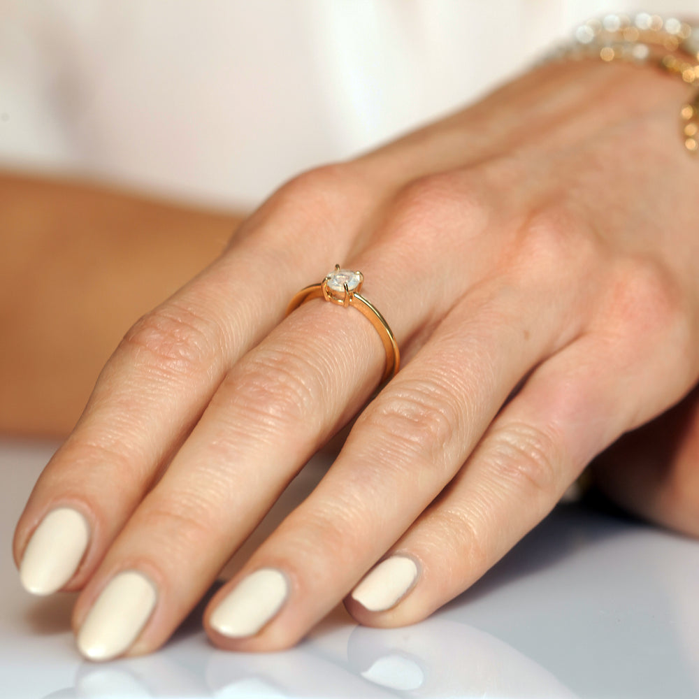 Close-up of woman wearing an opal ring in 18ct gold vermeil