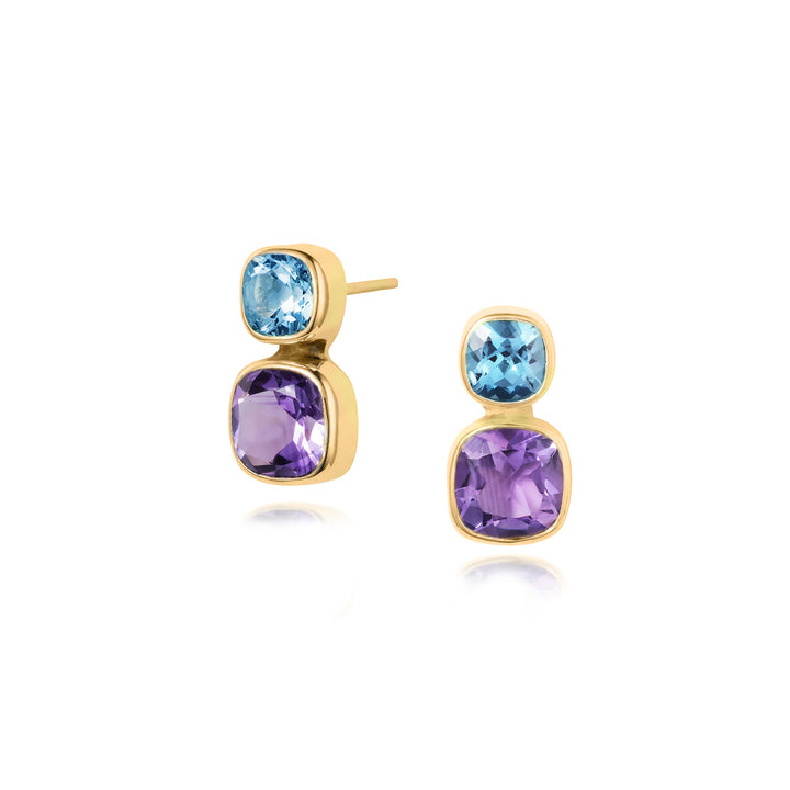 Gold earrings with blue and purple gemstones on a white background