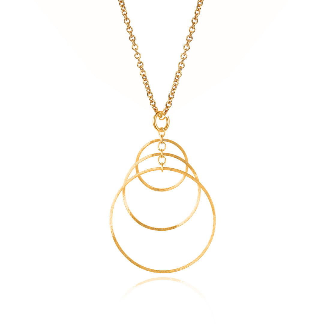 Gold necklace with three overlapping hoops on white background