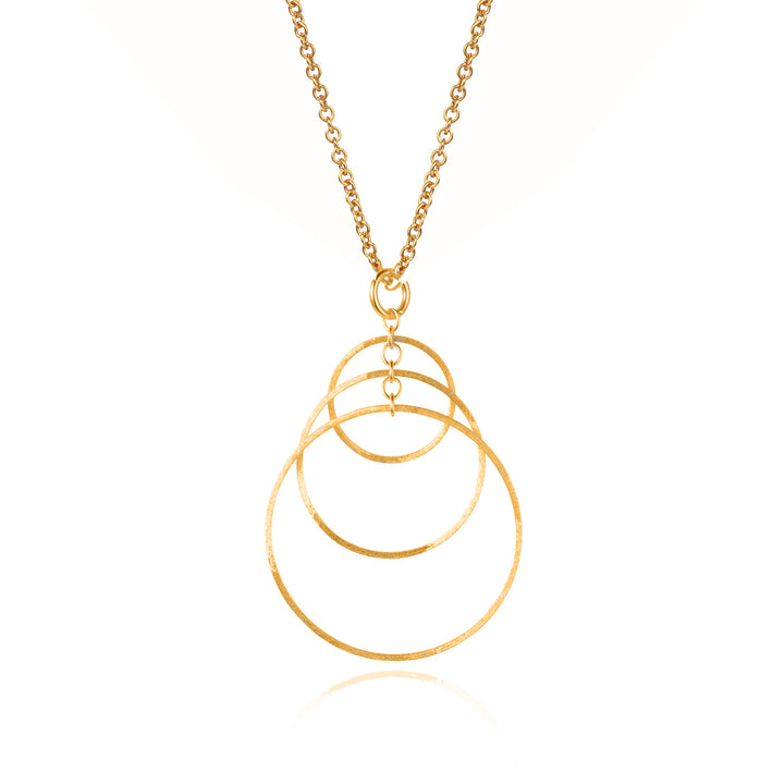 Gold necklace with three overlapping hoops on white background