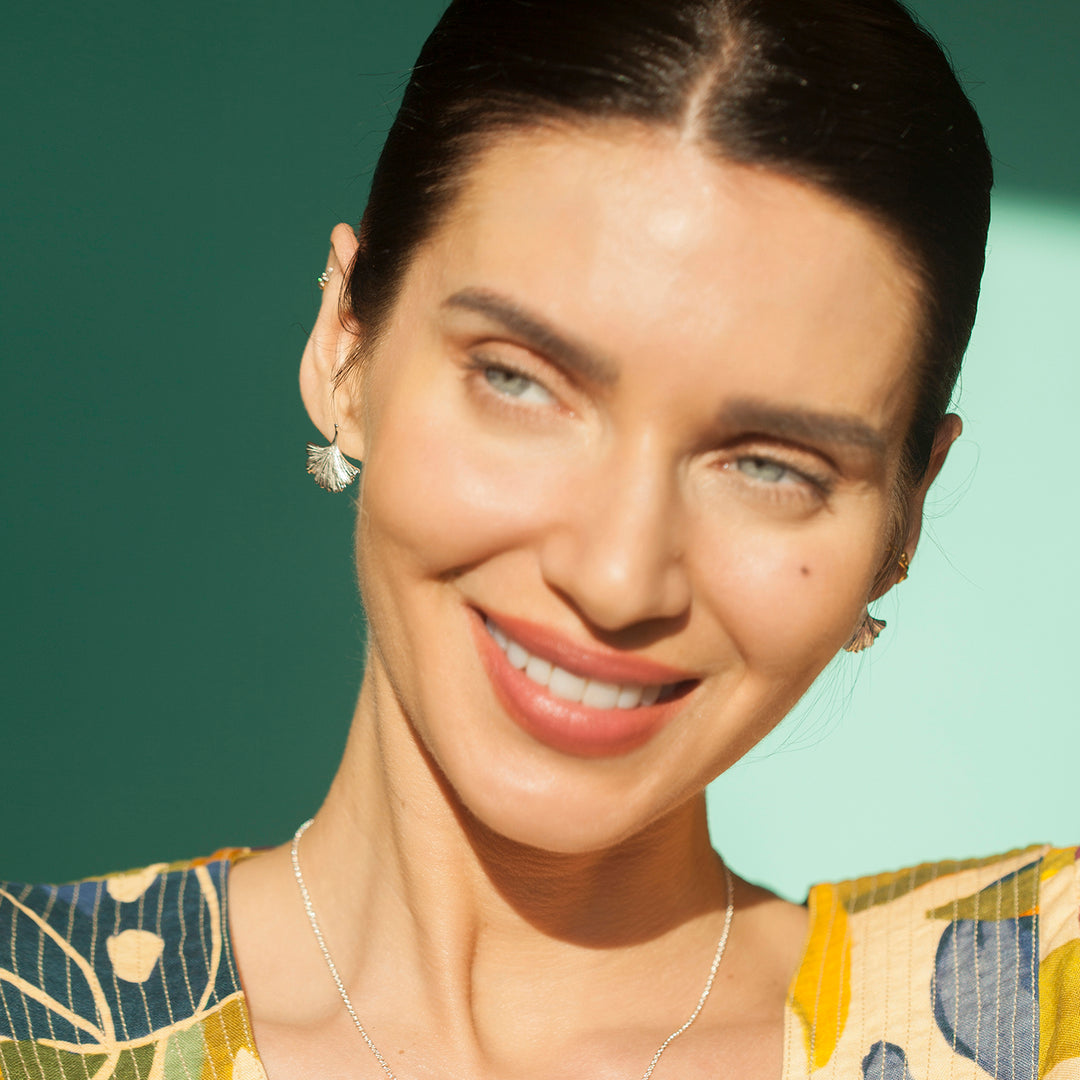 Model Wearing Ginkgo Leaf Stud Earrings In Silver