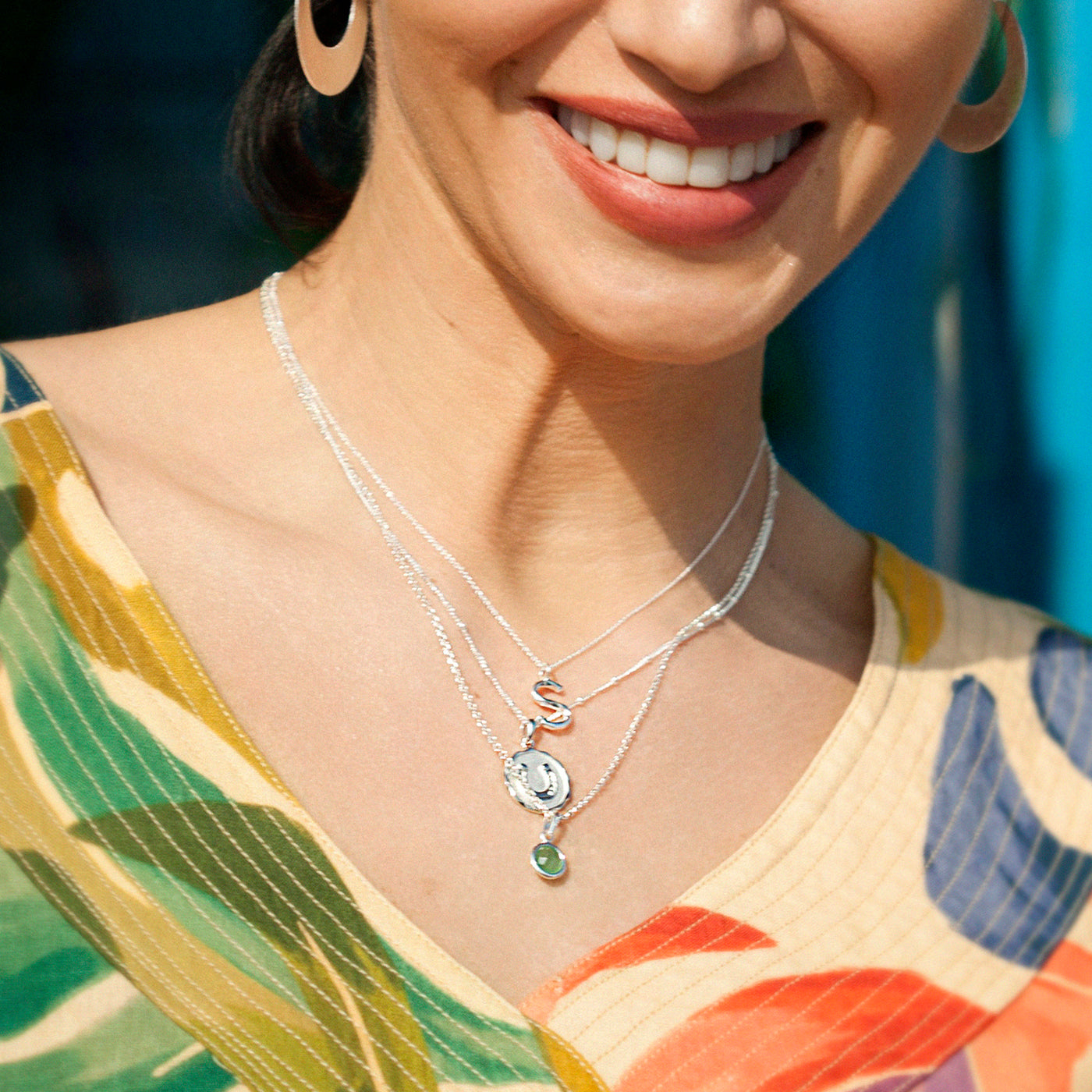 Model Wearing Initial Necklaces In Silver