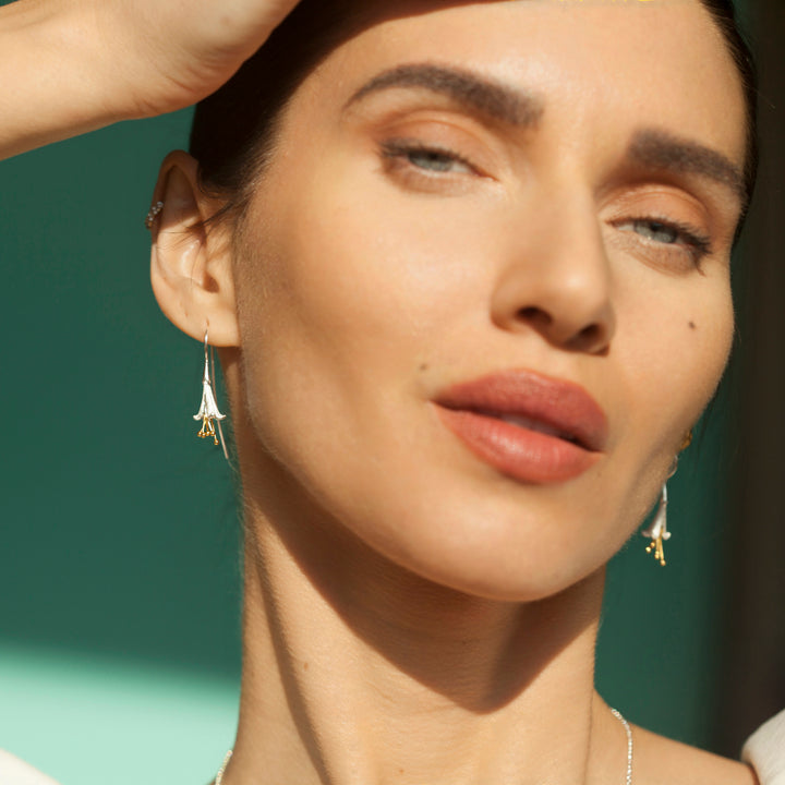 Model Wearing Fuchsia Flower Earring In Silver