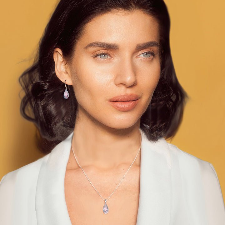 woman wearing sterling silver rose quartz pear drop earrings with matching necklace