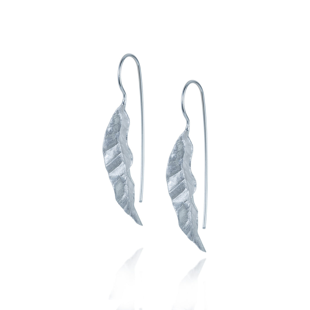 Silver tropical leaf-shaped earrings on a white background