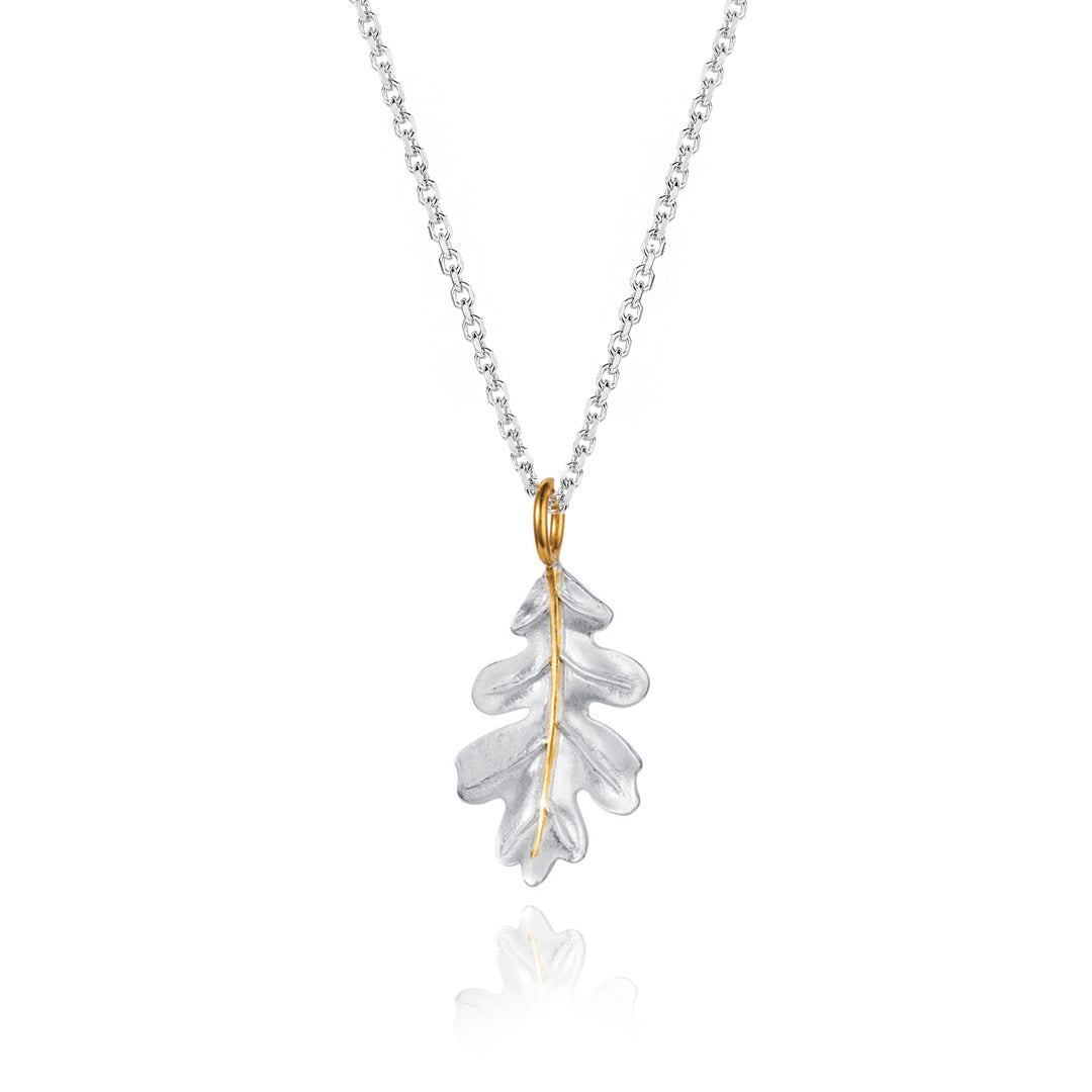 Silver oak leaf necklace with a gold details on a white background