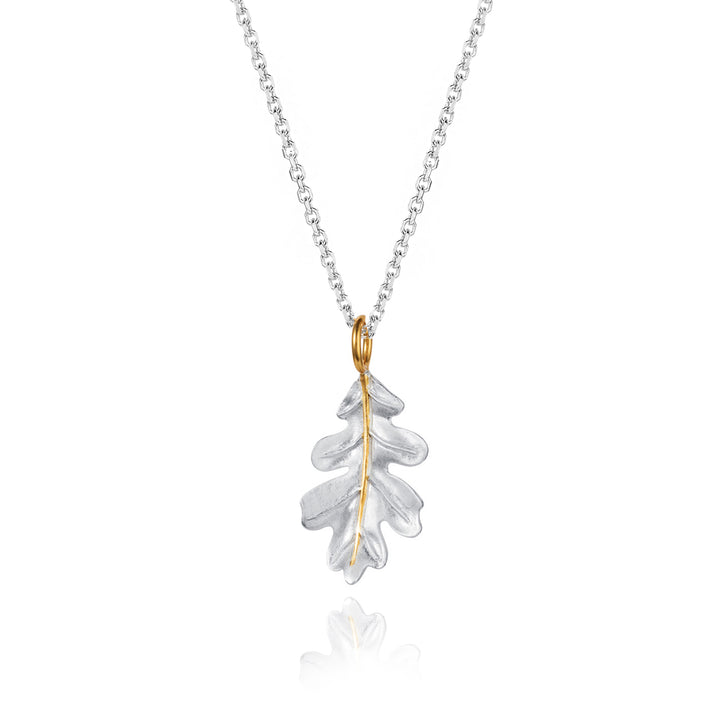 Silver oak leaf necklace with a gold details on a white background