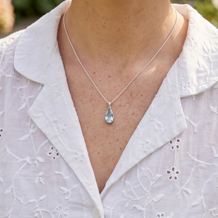 Close-up of Blue topaz pear drop pendant necklace set in sterling silver