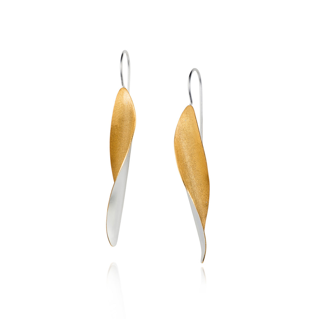 Pair of earrings with gold and silver leaf-like design on a white background