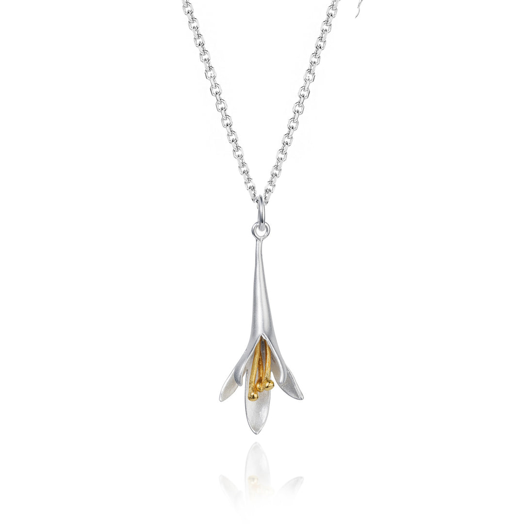 Silver and gold flower pendant necklace on a white background