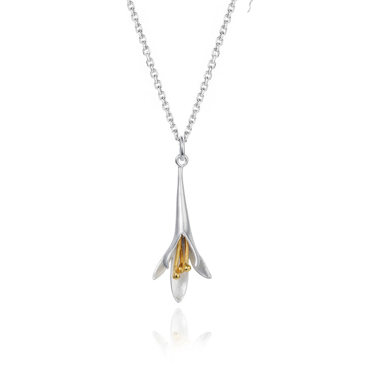 Silver and gold flower pendant necklace on a white background