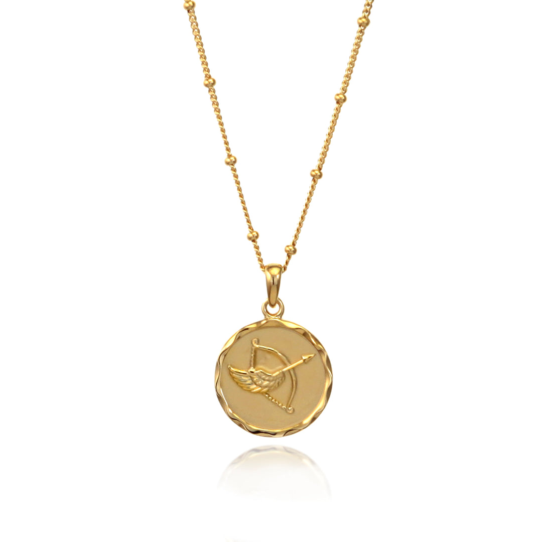 Gold Sagittarius star sign pendant necklace with a beaded chain on a white background