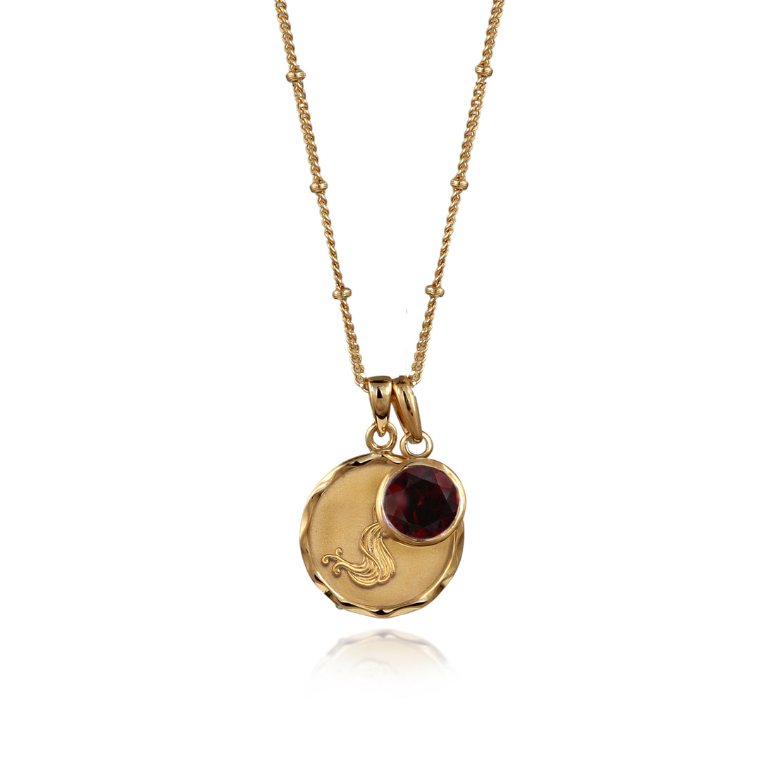 Gold Aquarius necklace with garnet January birthstone on a white background