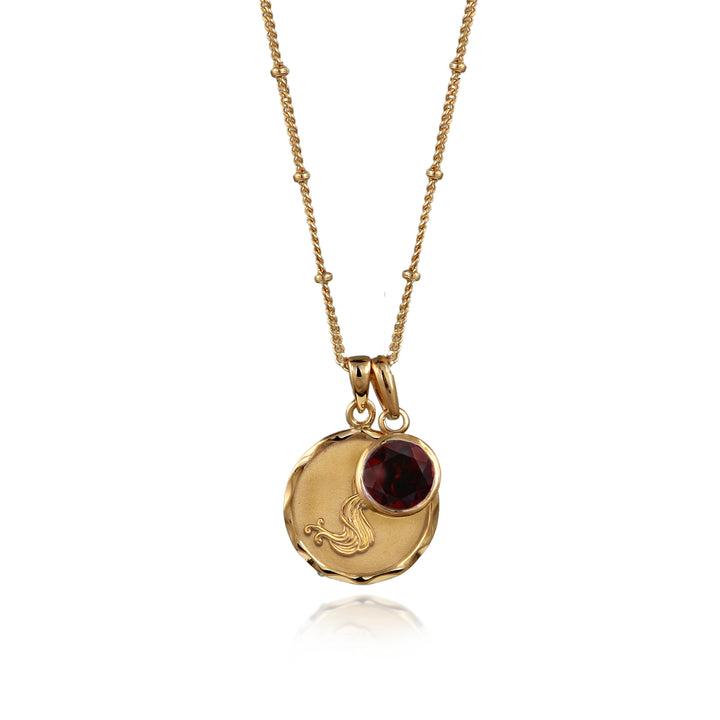 Gold Aquarius necklace with garnet January birthstone on a white background