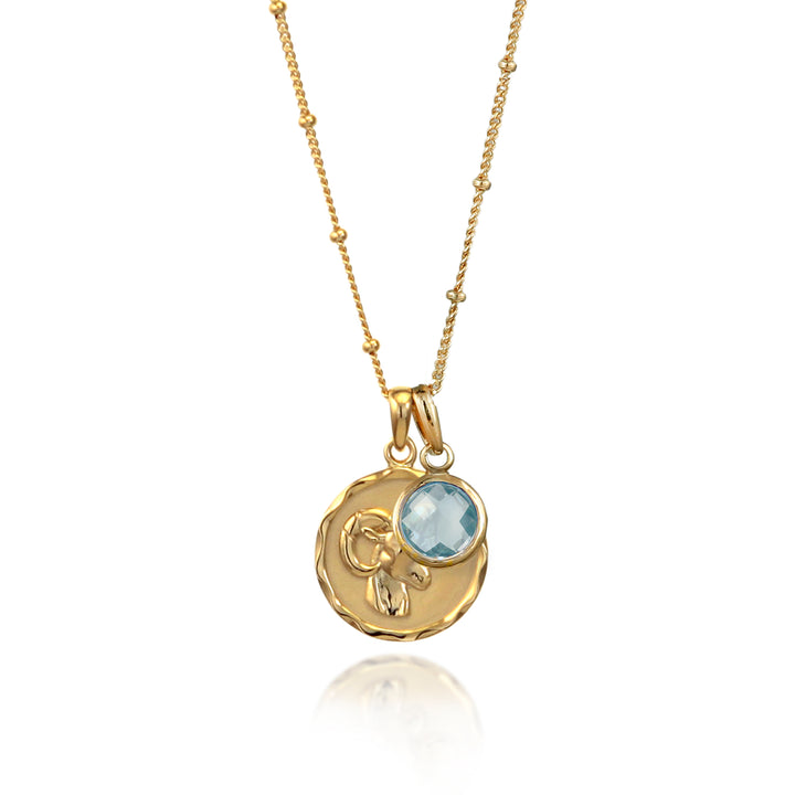 Gold vermeil Aries zodiac necklace with a blue topaz March birthstone charm