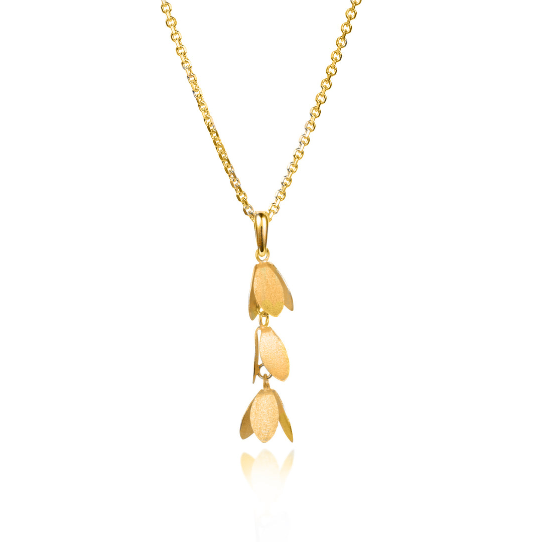 gold catkin flower shaped necklace on a white background