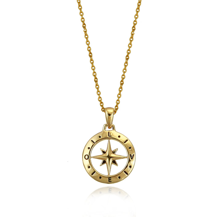 Gold compass pendant with the words love spelled out against a white background