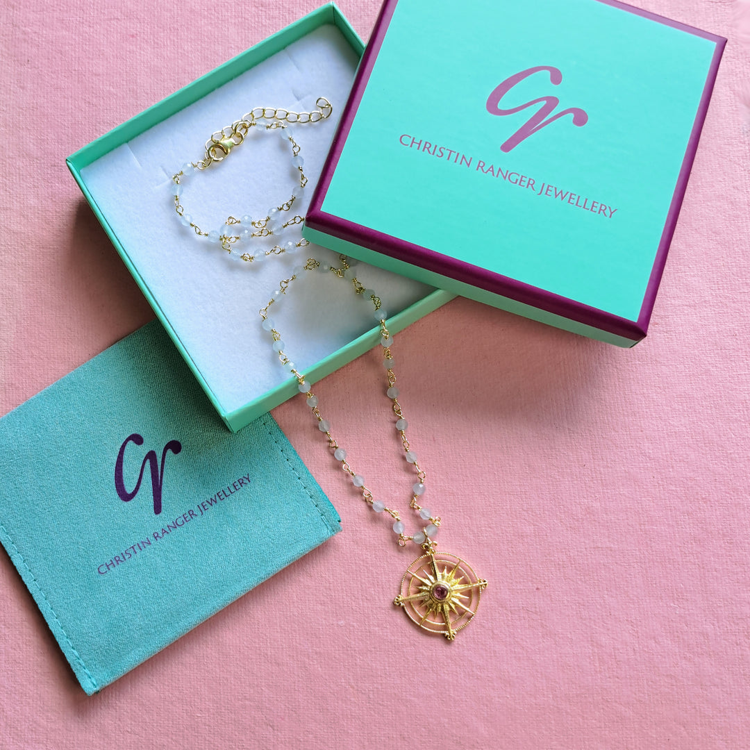 Gold tourmaline and blue chalcedony sun necklace in a Christin Ranger jewellery box.