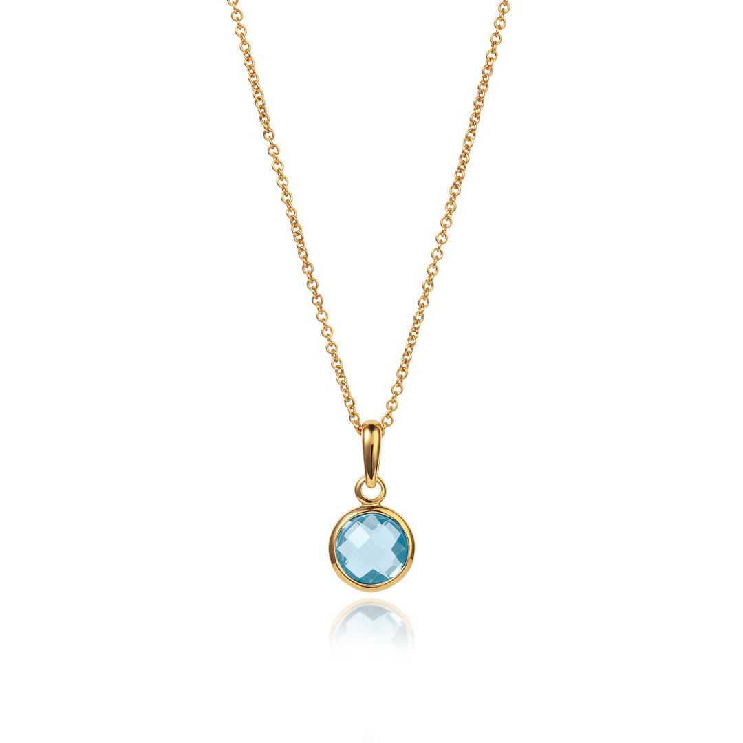 Dainty gold pendant with blue topaz on a gold chain
