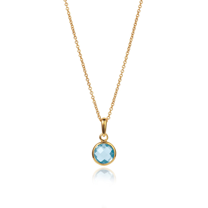 Dainty gold pendant with blue topaz on a gold chain