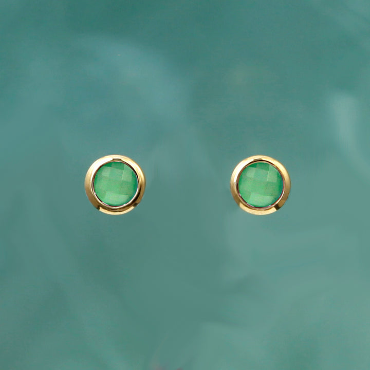 gold and green gemstone post earrings on an aqua background