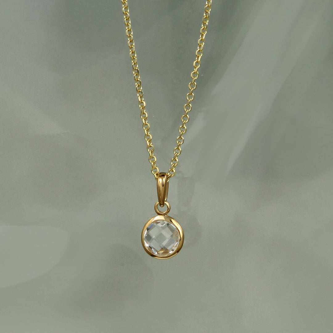 white topaz necklace in gold vermeil on an aqua background