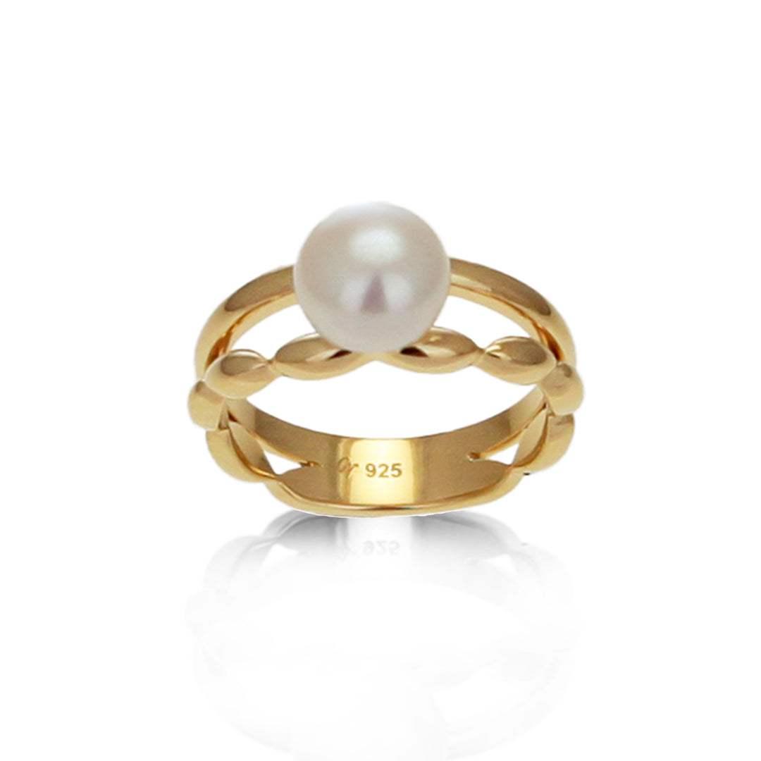 Front view of two banded gold ring set with a white pearl 