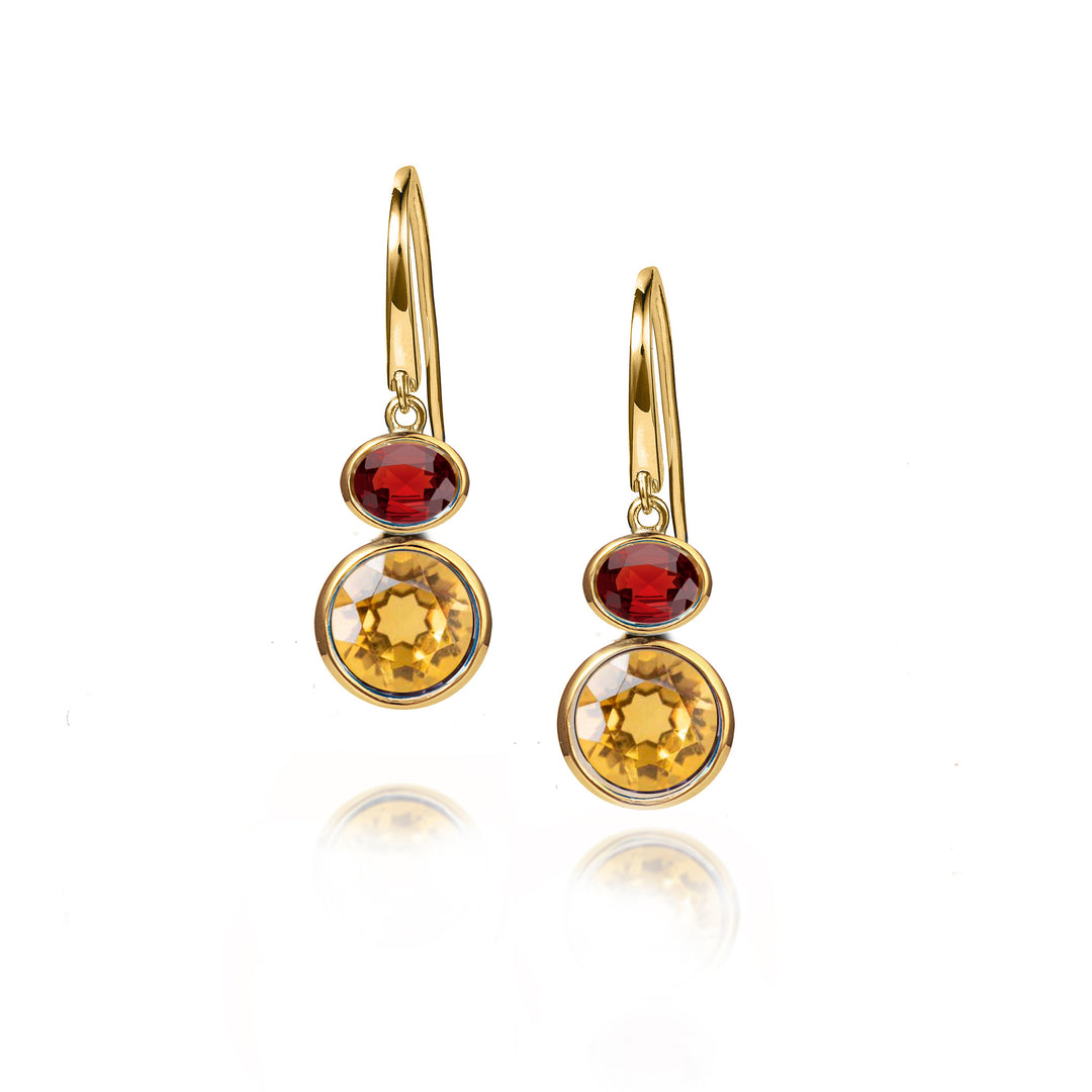 Gold hook earrings with red and yellow gemstones on a white background