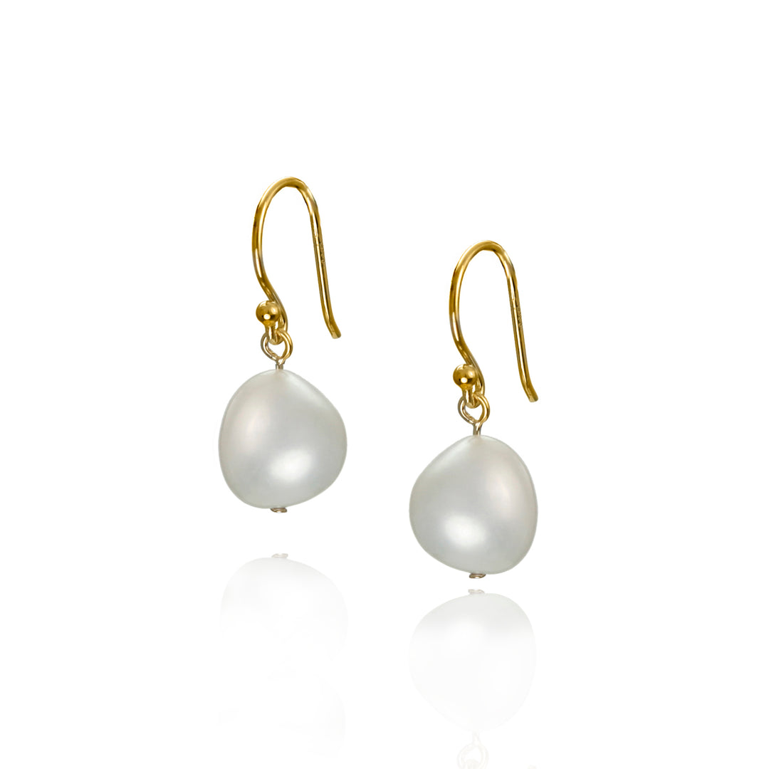 freshwater pearl earrings on gold hooks against a white background