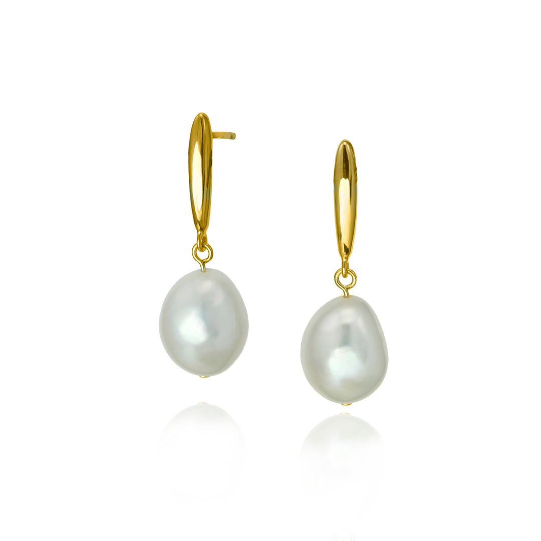 Freshwater pearls on long gold drops against a white background