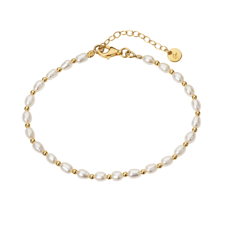 freshwater seed pearl and gold beaded bracelet on a white background