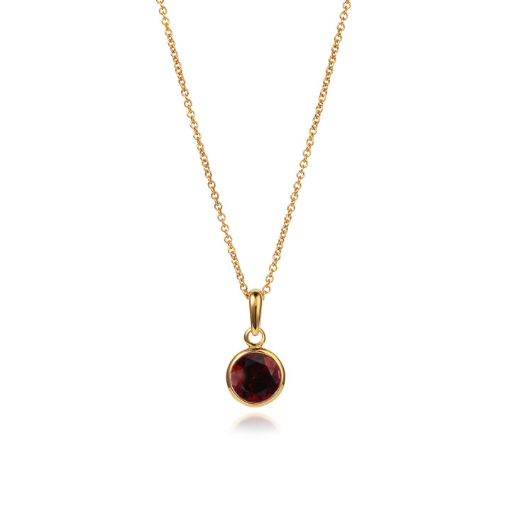 Gold vermeil necklace and chain with garnet gemstone on a white background