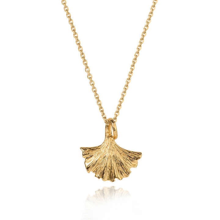 Gold necklace with a ginkgo leaf pendant on a white background