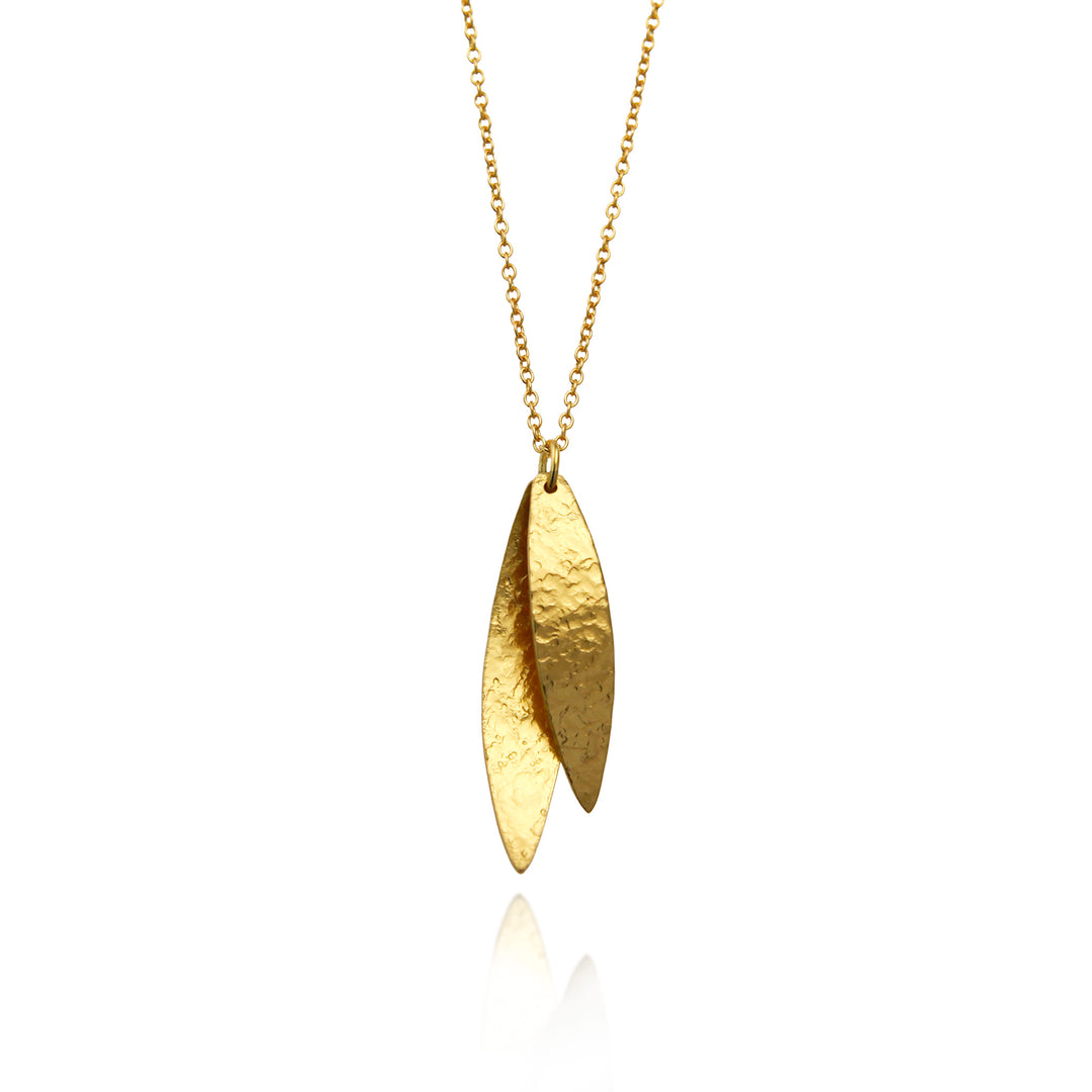 Shiny gold necklace with a leaf-shaped pendant on a white background