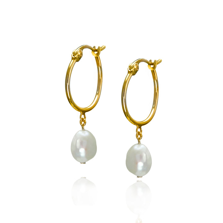 Gold hoop earrings with white pearls on a white background