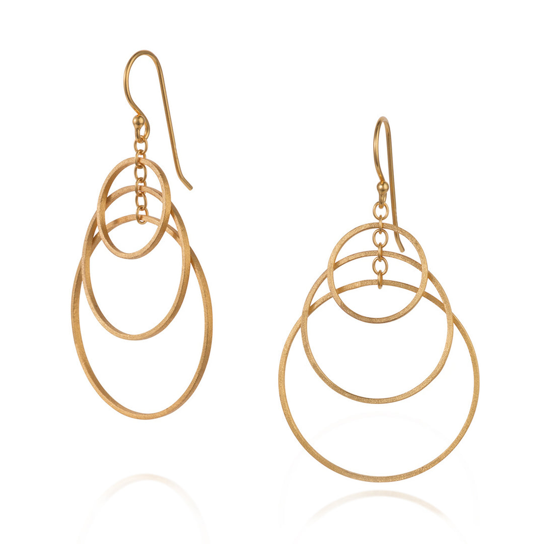 Gold hoop dangle earrings on a white background