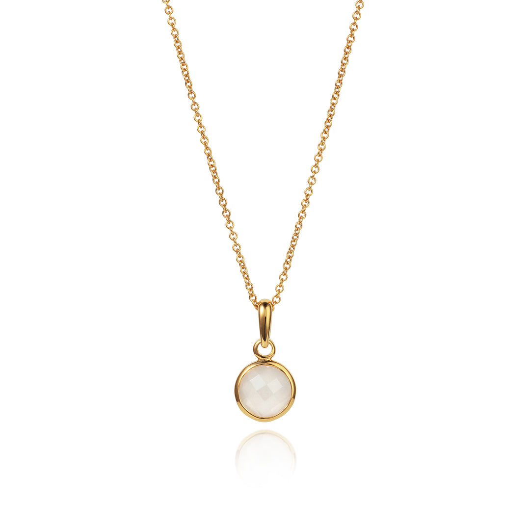 Dainty gold moonstone pendant with chain on a white background