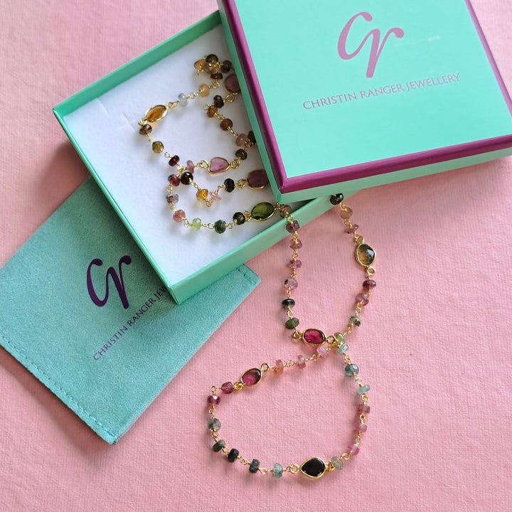Colourful beaded long necklace in a Christin Ranger Jewellery branded gift box on a pink background