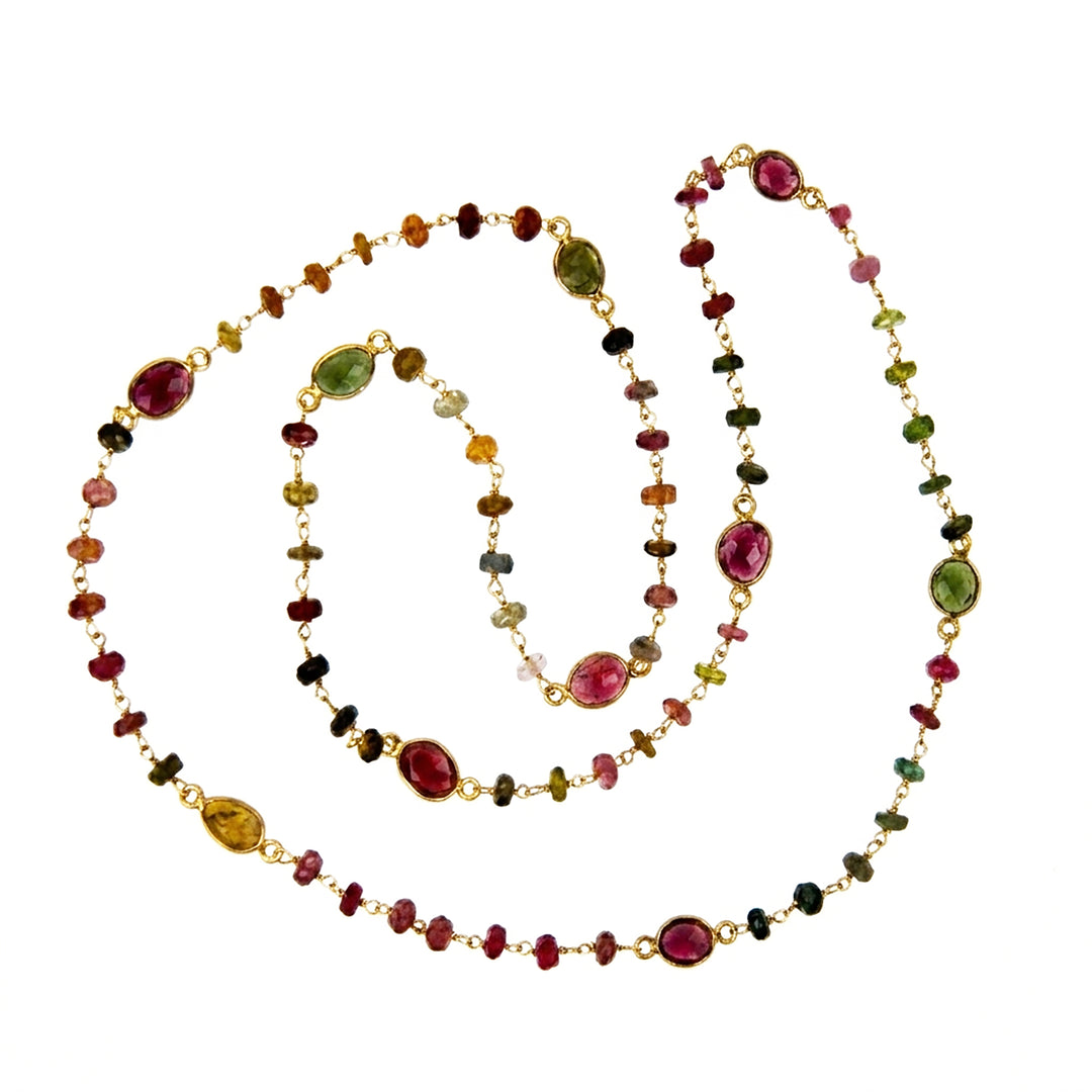 Multi-coloured tourmaline necklace with gold on a white background